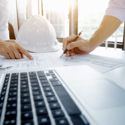 Engineer meeting for architectural project. working with partner Image of engineer meeting for architectural project. working with partner and engineering tools on workplace vintage tone.